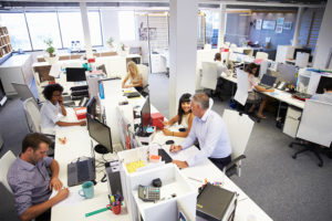Photo of a busy office filled with people, taken from a high vantage point