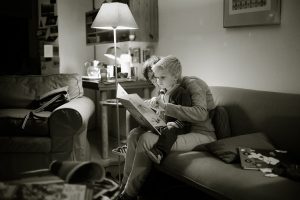 Child reading book with mother